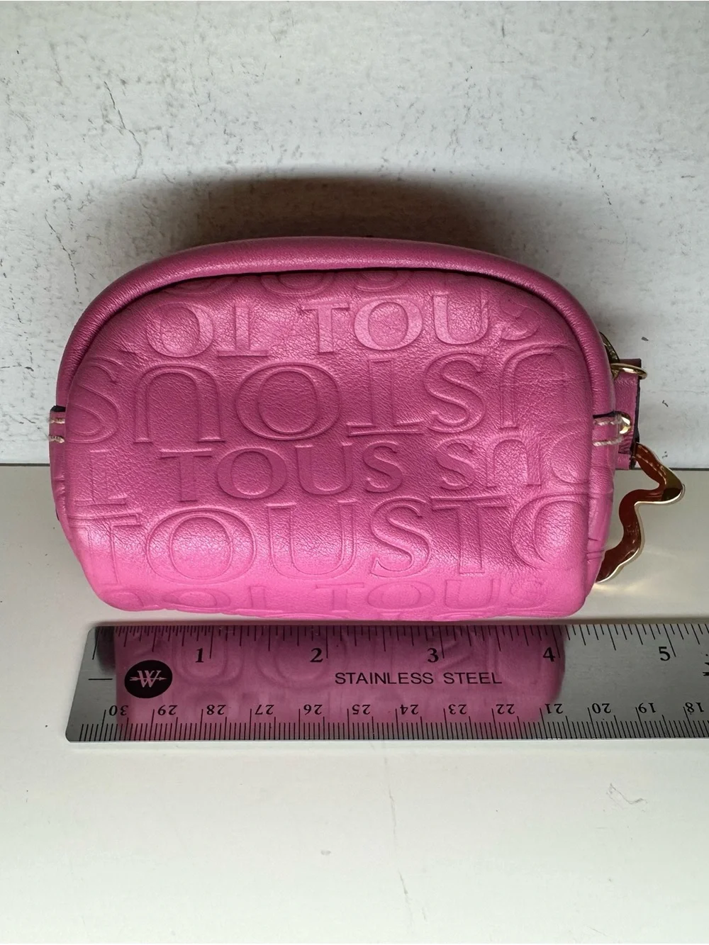 Tous embossed logo